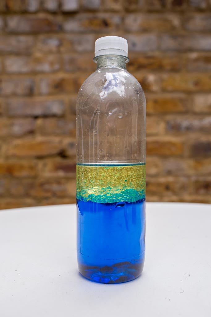 A water bottle with water, dye and vegetable oil