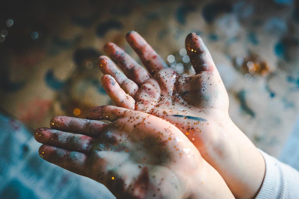 Hands covered in glitter after making Christmas decorations