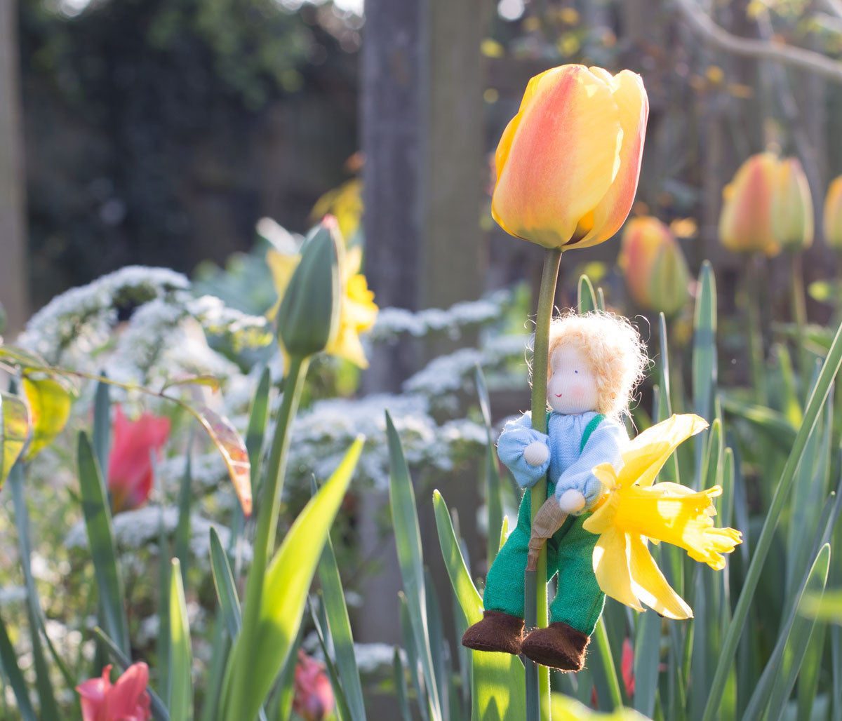 Grimm's doll among the flowers