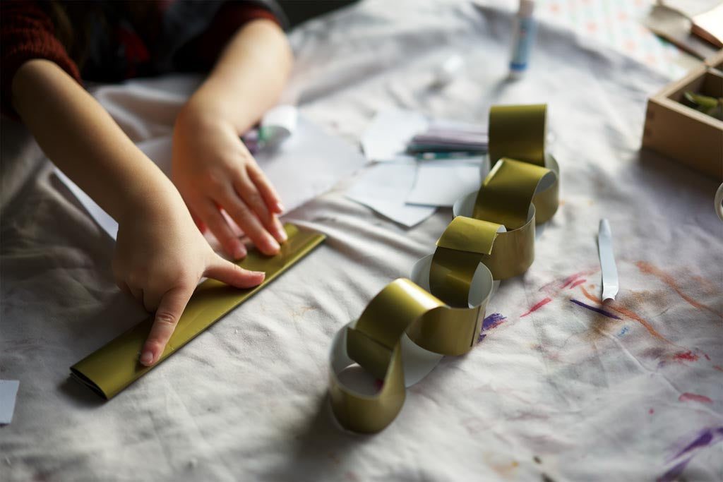 Child making a paper chain