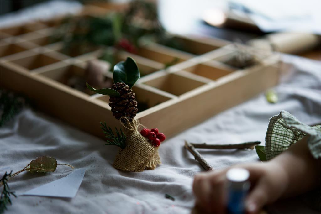 Making pine cones into Christmas tree ornaments