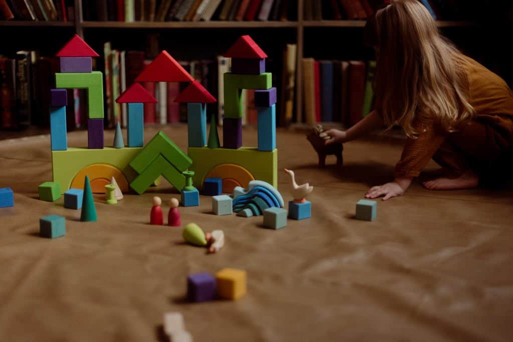 Child playing with Ostheimer deer, Grimm's blocks and loose parts