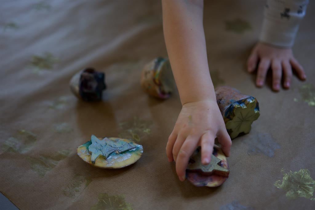 A child making potato-print wrapping paper