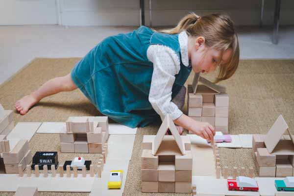 A girl playing with Just Blocks