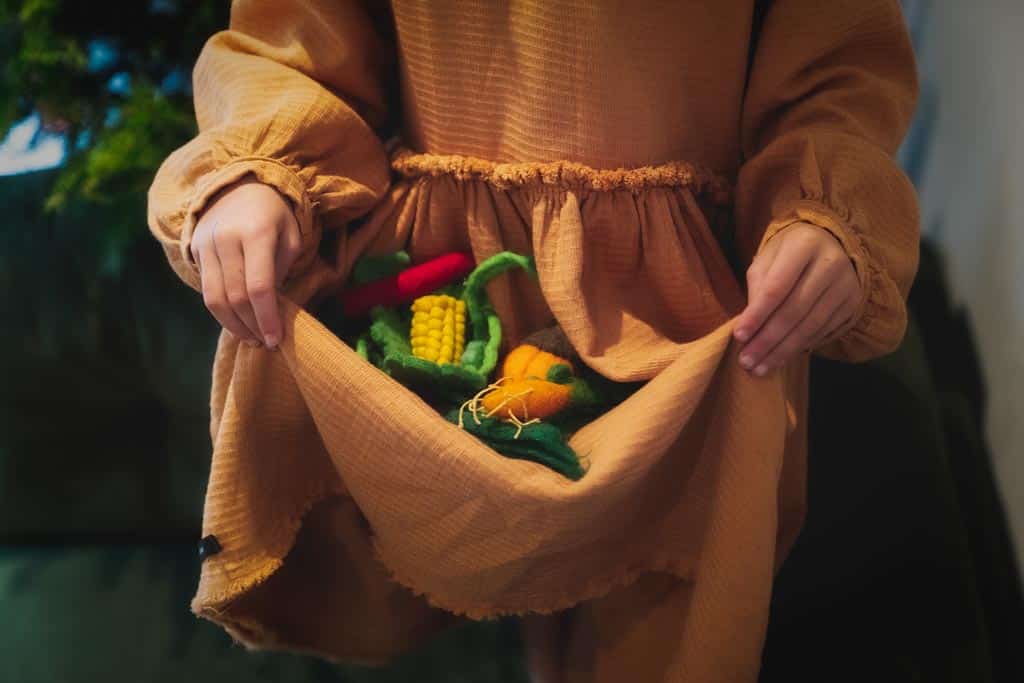 Transporting toy food in the fold of a dress