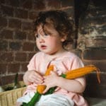 A toddler holding toys