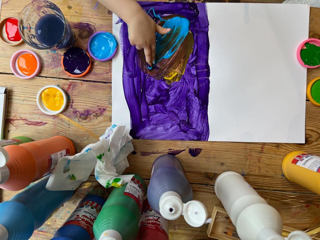 Process art - a child experimenting with finger painting