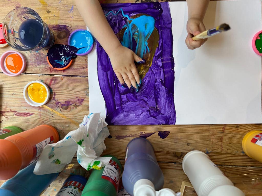 Process art - a child experimenting with hand prints