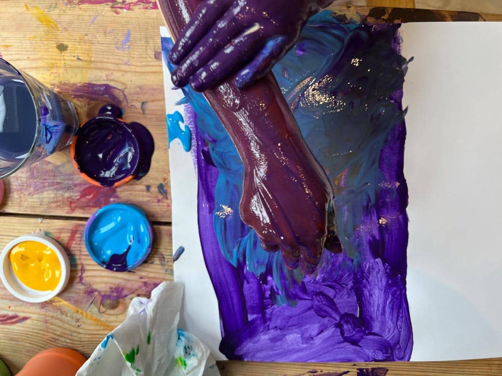 Process art - a child painting her arms