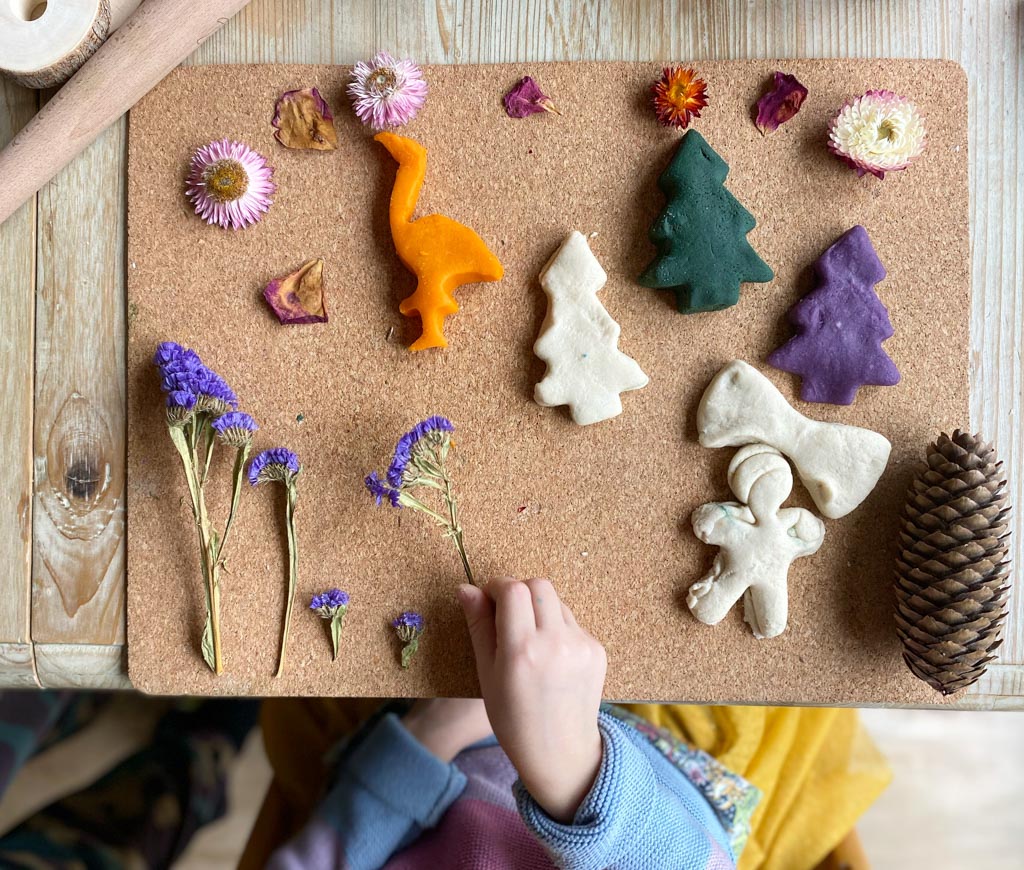 A transient art picture comprising playdough shapes and dried flowers