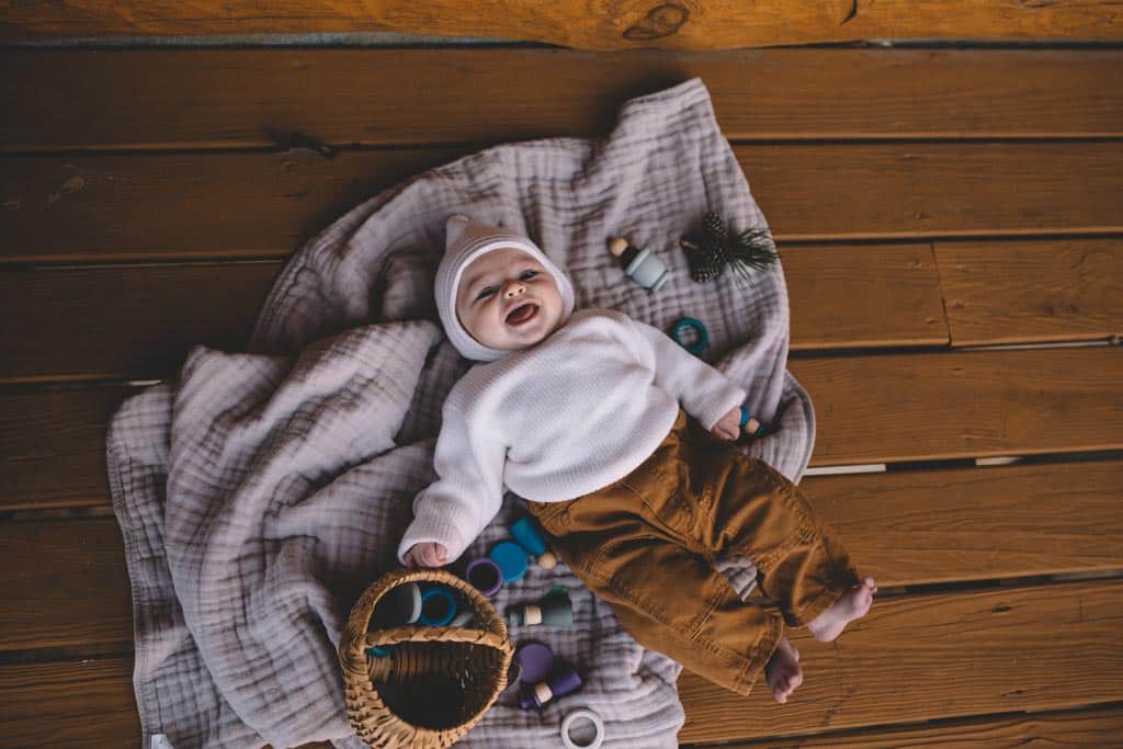 A child engaged in unoccupied play, lying on his back and looking around.