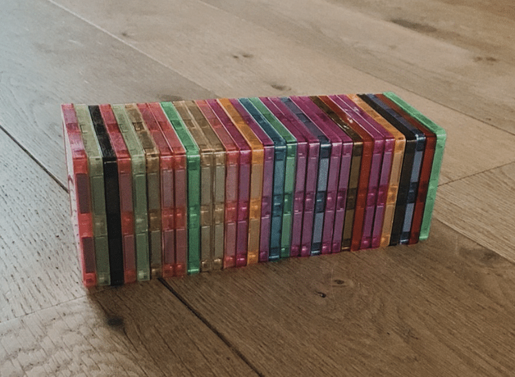 A stack of colourful magna tiles on the floor